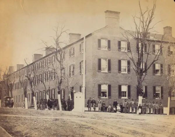 View on Pennsylvania Avenue, Washington, D.C.[Soldiers, civilians and children stand in front of a large brick corner building.]