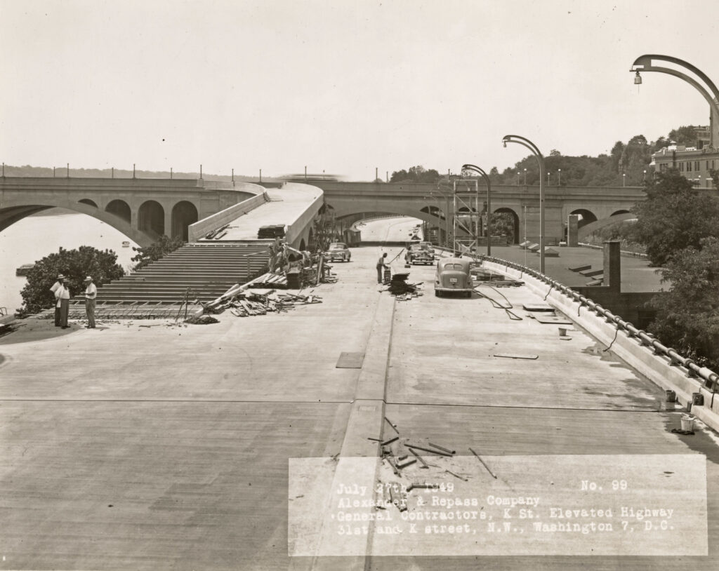 Construction progress on the Whitehurst Freeway in Georgetown, Washington D.C., 1949, showing elevated steel structure over K Street.
