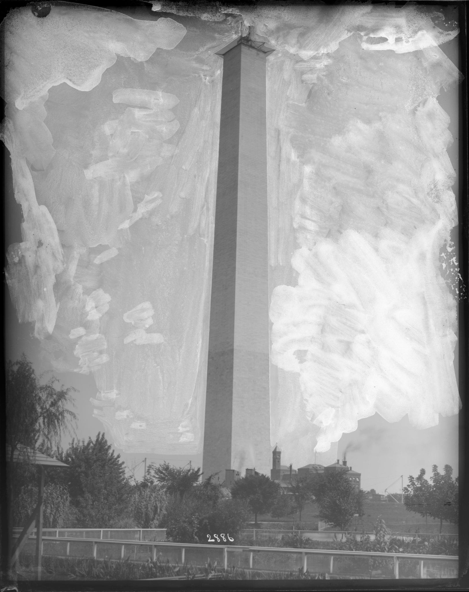 Washington Monument under construction with U.S. Fish Commission hatching ponds in the foreground and Bureau of Engraving and Printing building in the background.