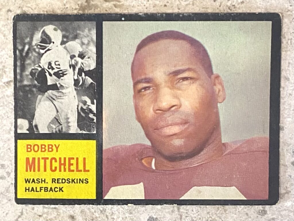 Bobby Mitchell's 1962 Topps football card, highlighting his significant role as a pioneering player helping the Redskins become last NFL team to integrate.