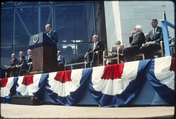 US President Gerald R. Ford speaks at the Smithsonian National Air and Space Museum's opening, July 4, 1976, with dignitaries in attendance.