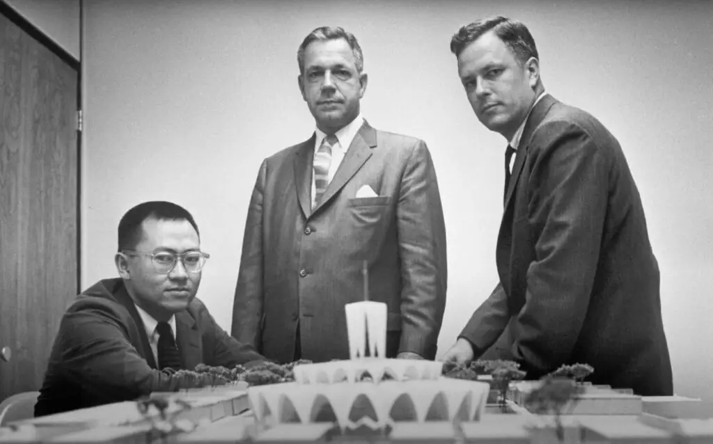 HOK’s founders: Gyo Obata, George Hellmuth and George Kassabaum with a model of the Priory Chapel at Saint Louis Abbey.