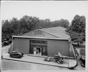 Historical image of the Quonset Hut behind the Smithsonian Castle, serving as the National Air Museum, later the National Air and Space Museum, from 1917 to 1975. In the foreground, a French Renault tank and a German howitzer.