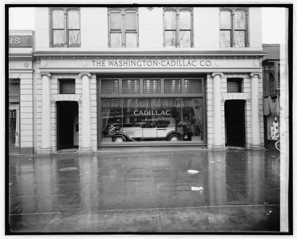 A historic photograph, created between 1910 and 1926, depicting the Washington Cadillac Co. The image is a glass negative, characteristic of early 20th-century photography. The photograph's title and details were provided by unverified data from the National Photo Company, indicated on the negative or its sleeve.