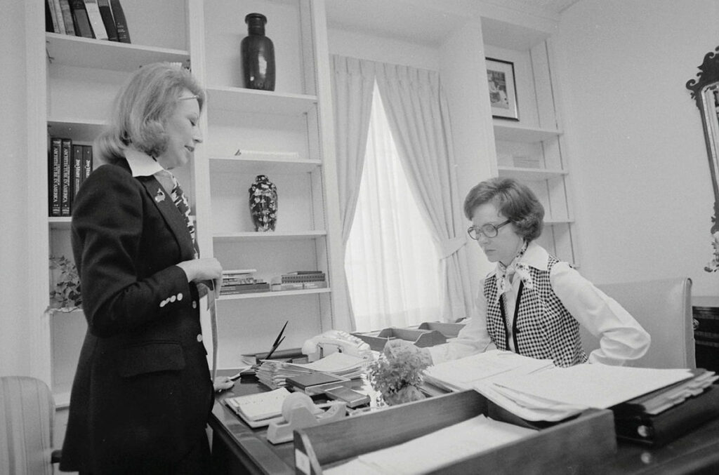First Lady Rosalynn Carter sits at her desk in the East Wing office while working with personal assistant Madeline McBean on March 17, 1977.Retry