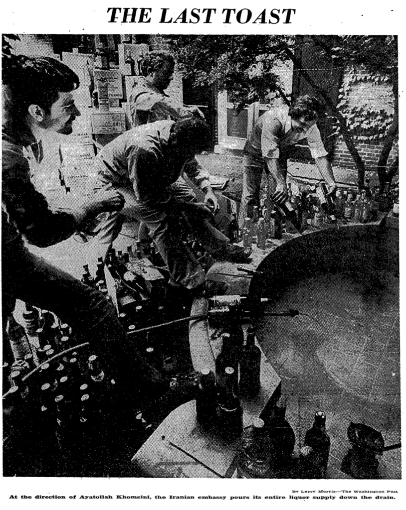 Embassy workers pour bottles of liquor down the drain at the Iranian embassy, May 1979