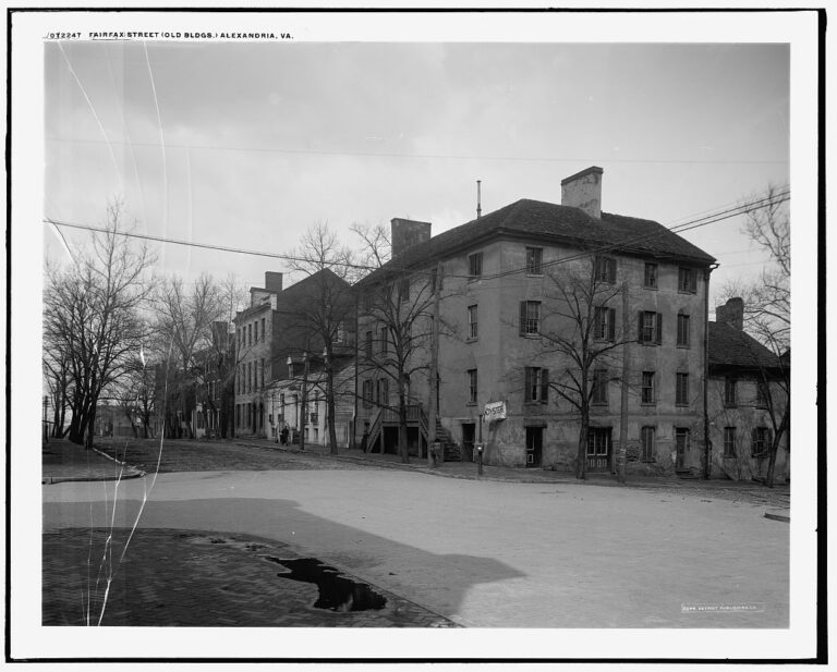 Row of historic brick and clapboard buildings along Fairfax Street in Alexandria, Virginia, photographed between 1910 and 1920.