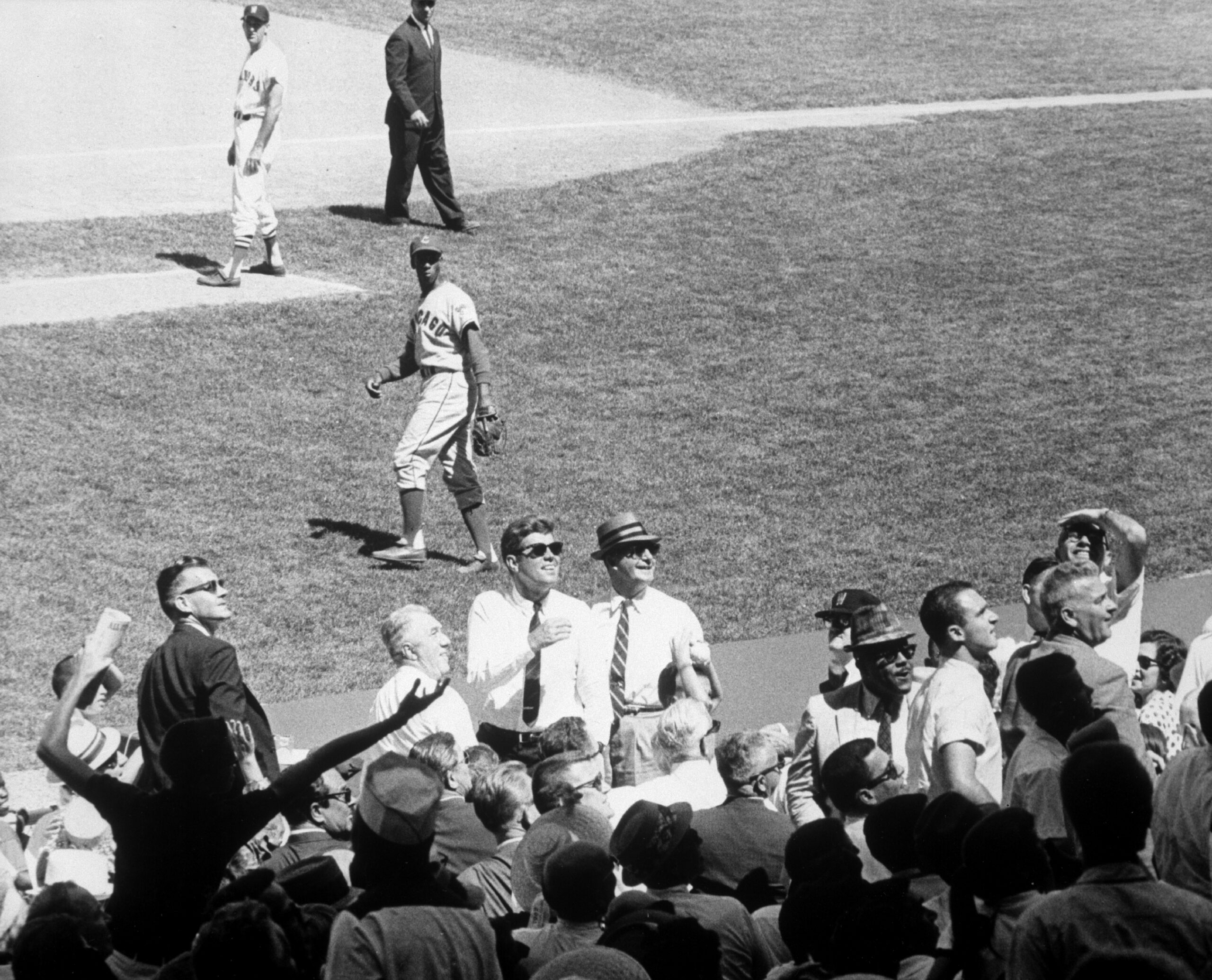 Kennedy in sunglasses watching the 1962 All-Star Game from his box seat.