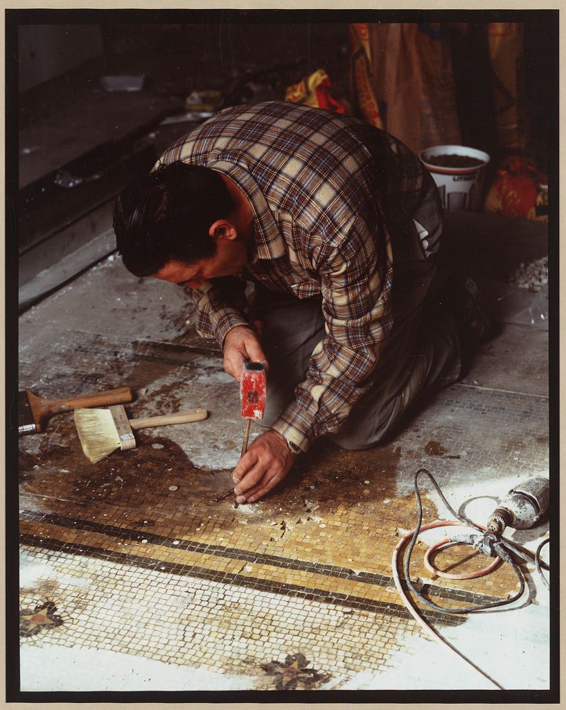 Workers fitting tile pieces into the Willard Hotel lobby floor during the 1985 restoration