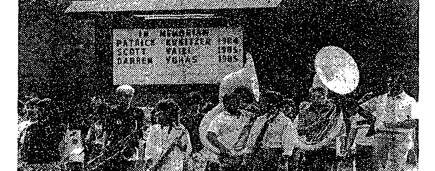 Bowie High School band practices near a sign memorializing Patrick Kreitzer, Scott Vaill, and Darren Yuhas, 1986