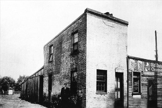 Crandal Mackey standing in front of Charles Knoxville's Sunday bar in Rosslyn, 1903