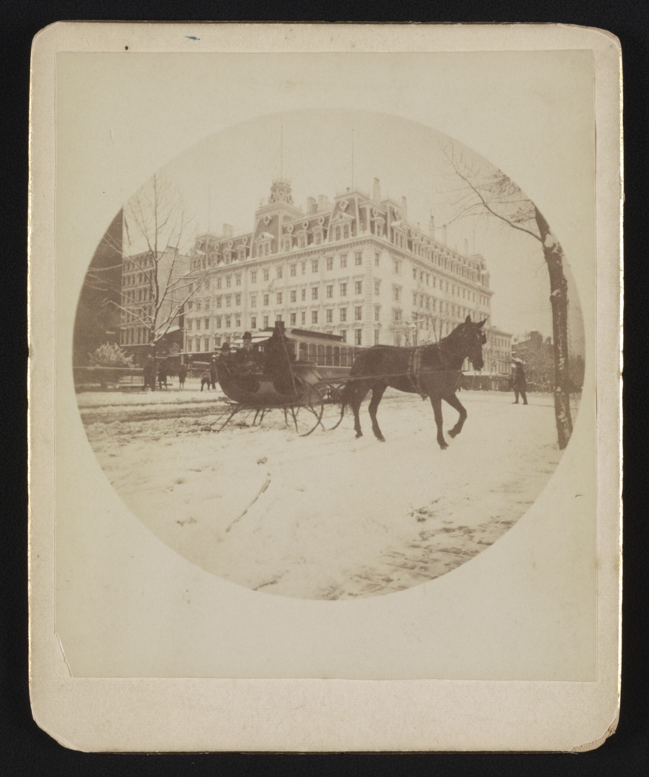 Horse-drawn sleigh in the snow in front of the Ebbitt House, late 1880s