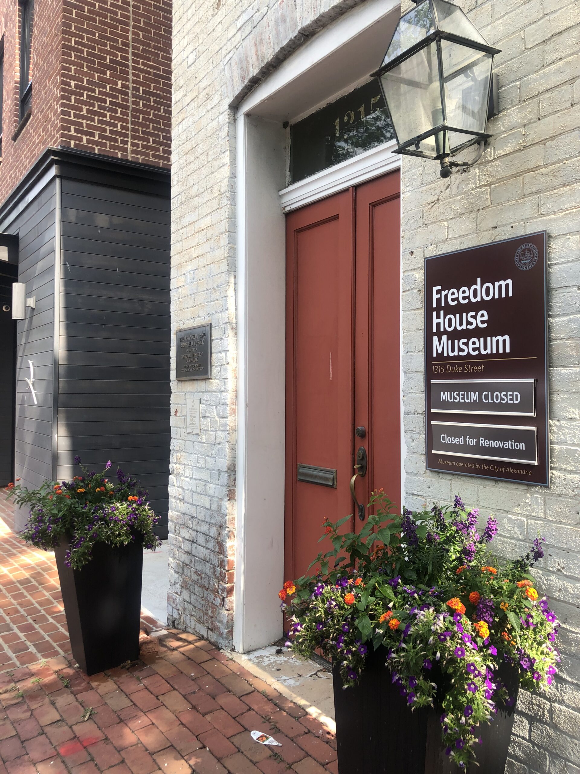 Modern color photograph of the Freedom House Museum, the Federal-style brick building at 1315 Duke Street in Alexandria, Virginia