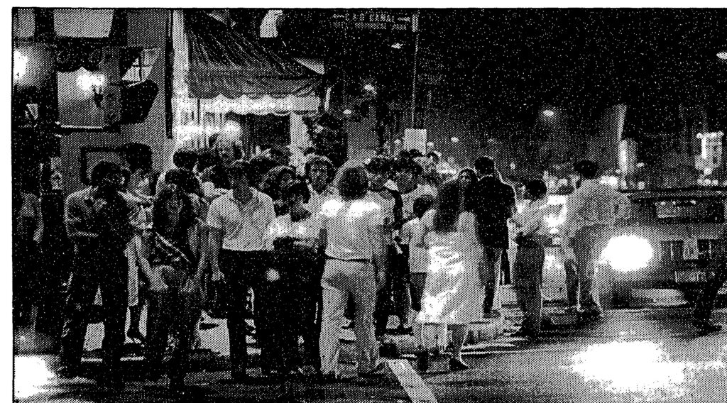 Crowds at the corner of M Street and Wisconsin Avenue in Georgetown at midnight, 1982