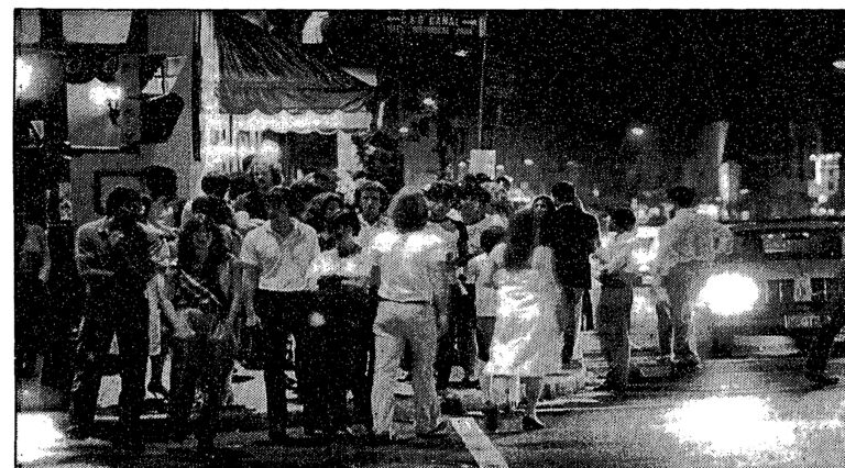 Crowds at the corner of M Street and Wisconsin Avenue in Georgetown at midnight, 1982