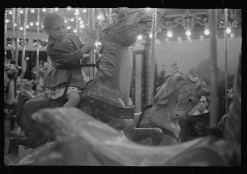A young girl rides the Dentzel carousel at Glen Echo Park in 1939