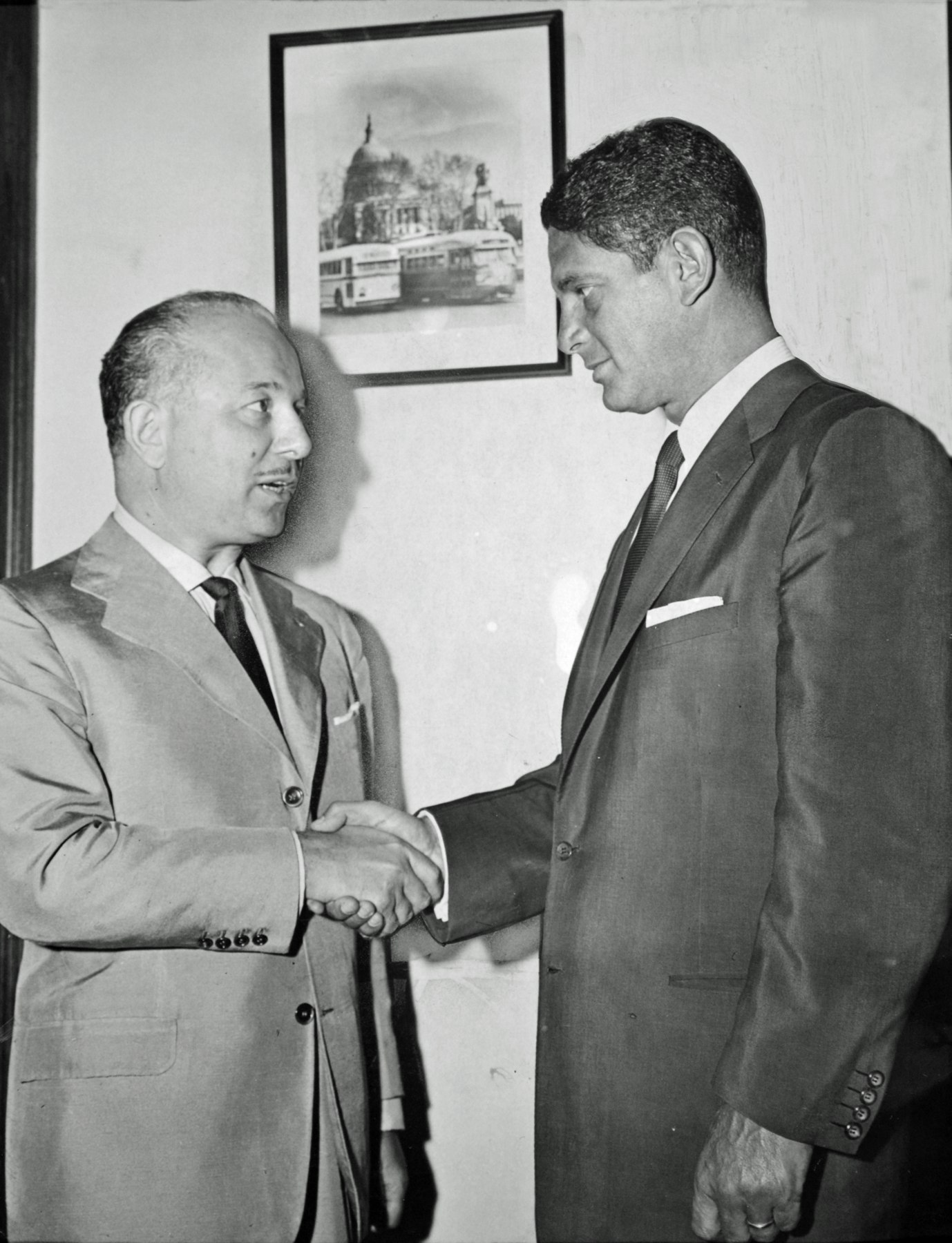 O. Roy Chalk and Louis Wolfson shake hands as they complete the sale of Capital Transit, August 3, 1956