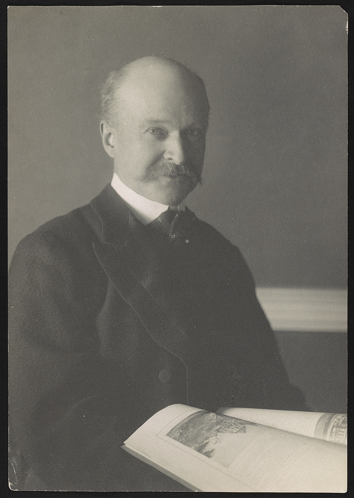 Charles Follen McKim half-length portrait with opened journal in 1890, photographed by Frances Benjamin Johnston more than a decade before he was hired for the 1902 White House renovation.