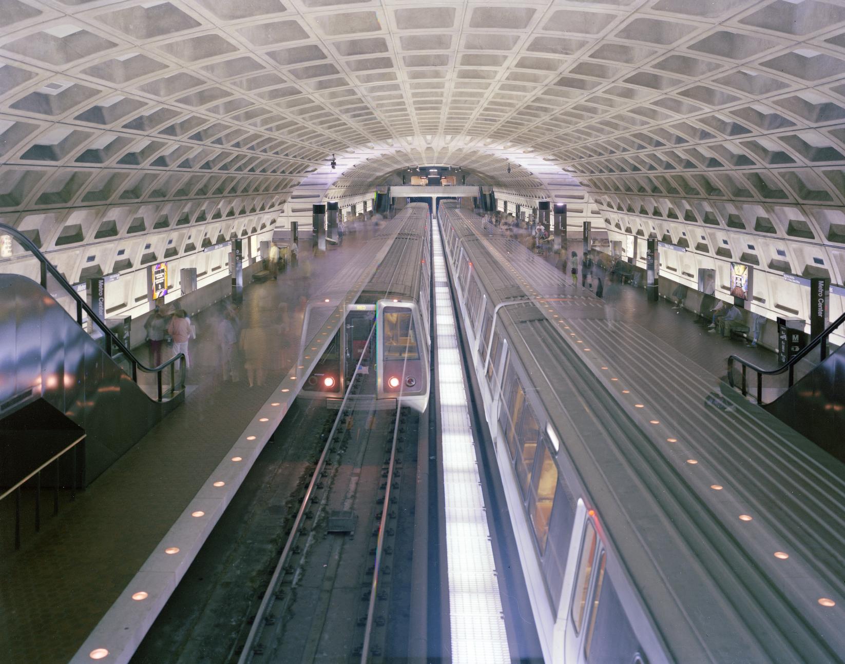 Two Red Line trains arrive at Metro Center station beneath downtown Washington, the iconic Harry Weese coffered vault overhead, photographed in 1980.
