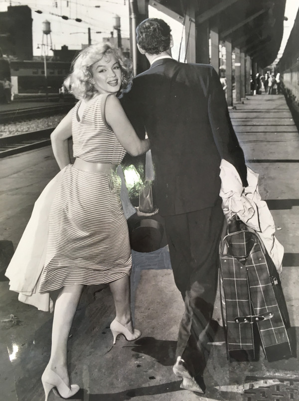 Marilyn Monroe smiles for the photographer as she and her husband, playwright Arthur Miller, catch a train for New York at Washington's Union Station in 1957.