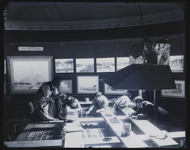 Workers in 1902 hunched over a large scale model of Washington for the McMillan Commission, with renderings of the proposed Mall hanging on the walls around them.