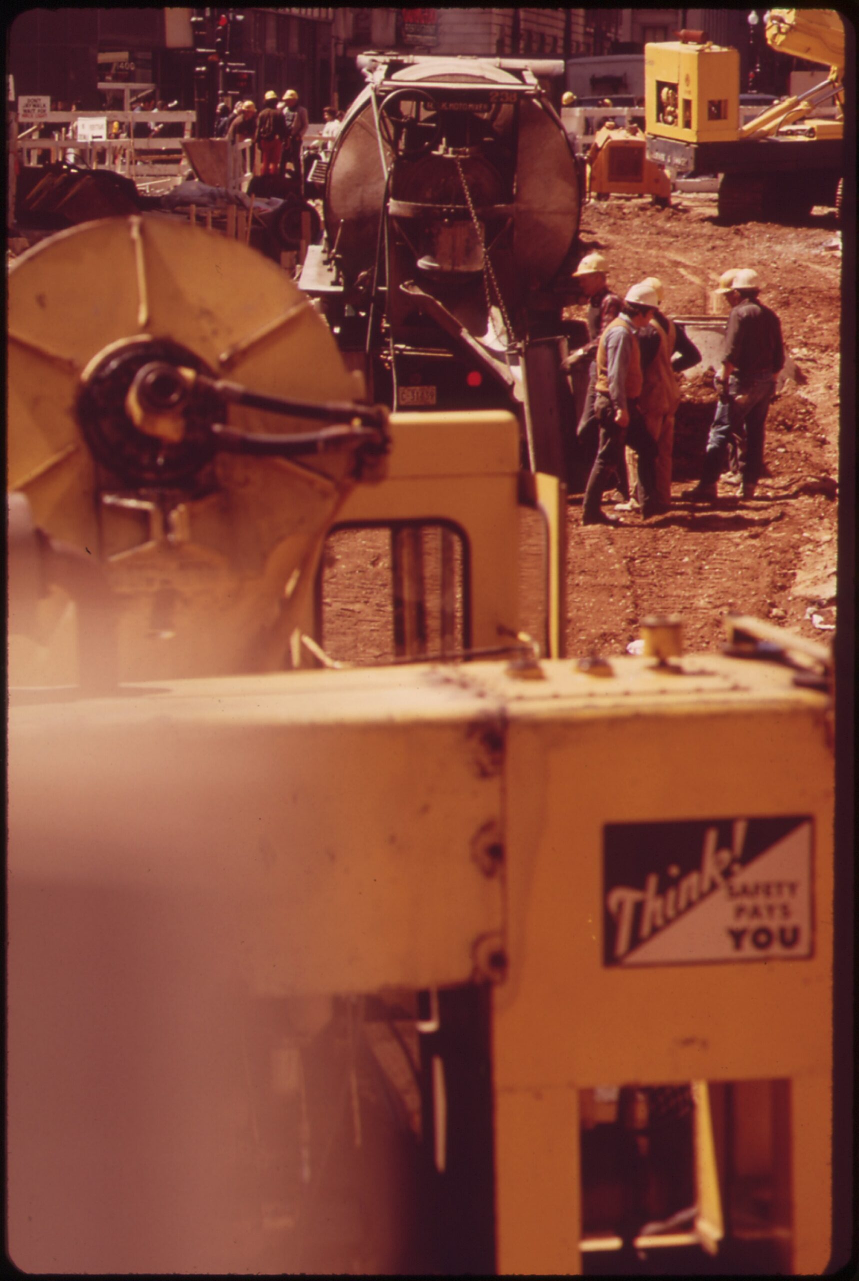 Crews tear open G Street NW between 13th and 14th in 1973 to build the downtown Metro subway, with downtown traffic squeezing past the construction zone.
