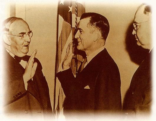 Black-and-white photograph of John C. Stennis being sworn in as a U.S. senator with James O. Eastland beside him