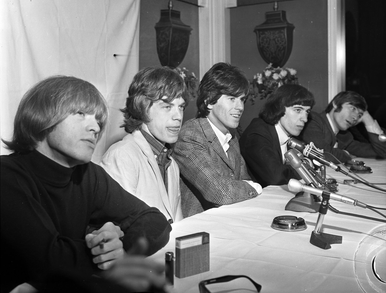 The Rolling Stones at a Beverly Hills press conference on their 1965 American tour. From left: Brian Jones in a black turtleneck, Mick Jagger, Keith Richards, Bill Wyman, and Charlie Watts.