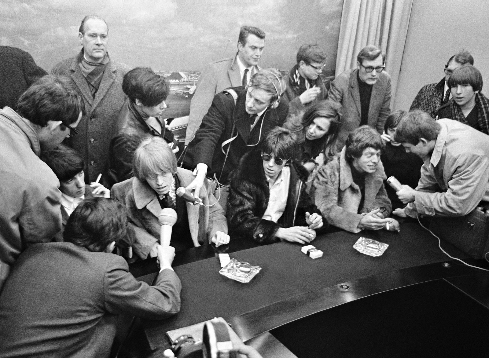 The Rolling Stones swarmed by reporters at Schiphol Airport, Amsterdam, on the 1966 European tour.