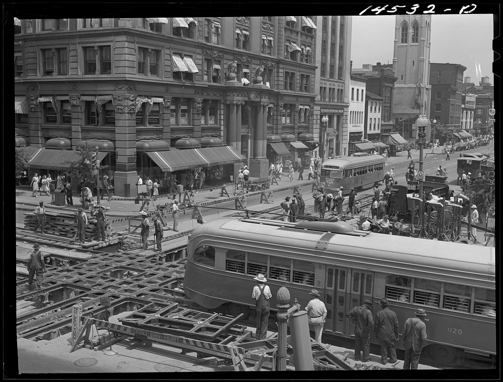 Workers repairing streetcar tracks and the underground conduit slot at 14th and G Streets NW in 1941.