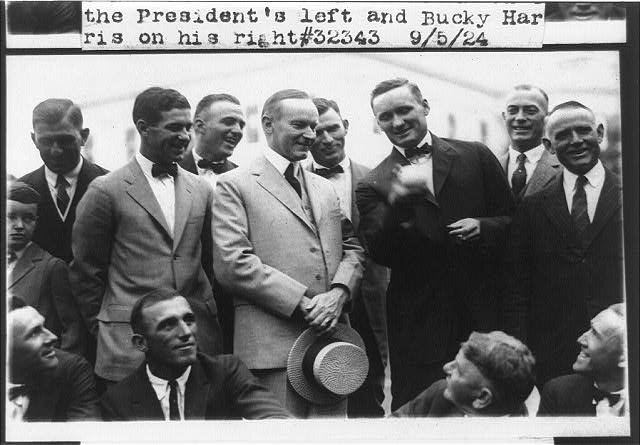 Walter Johnson demonstrates his curveball grip to President Calvin Coolidge with Bucky Harris at right, 1924