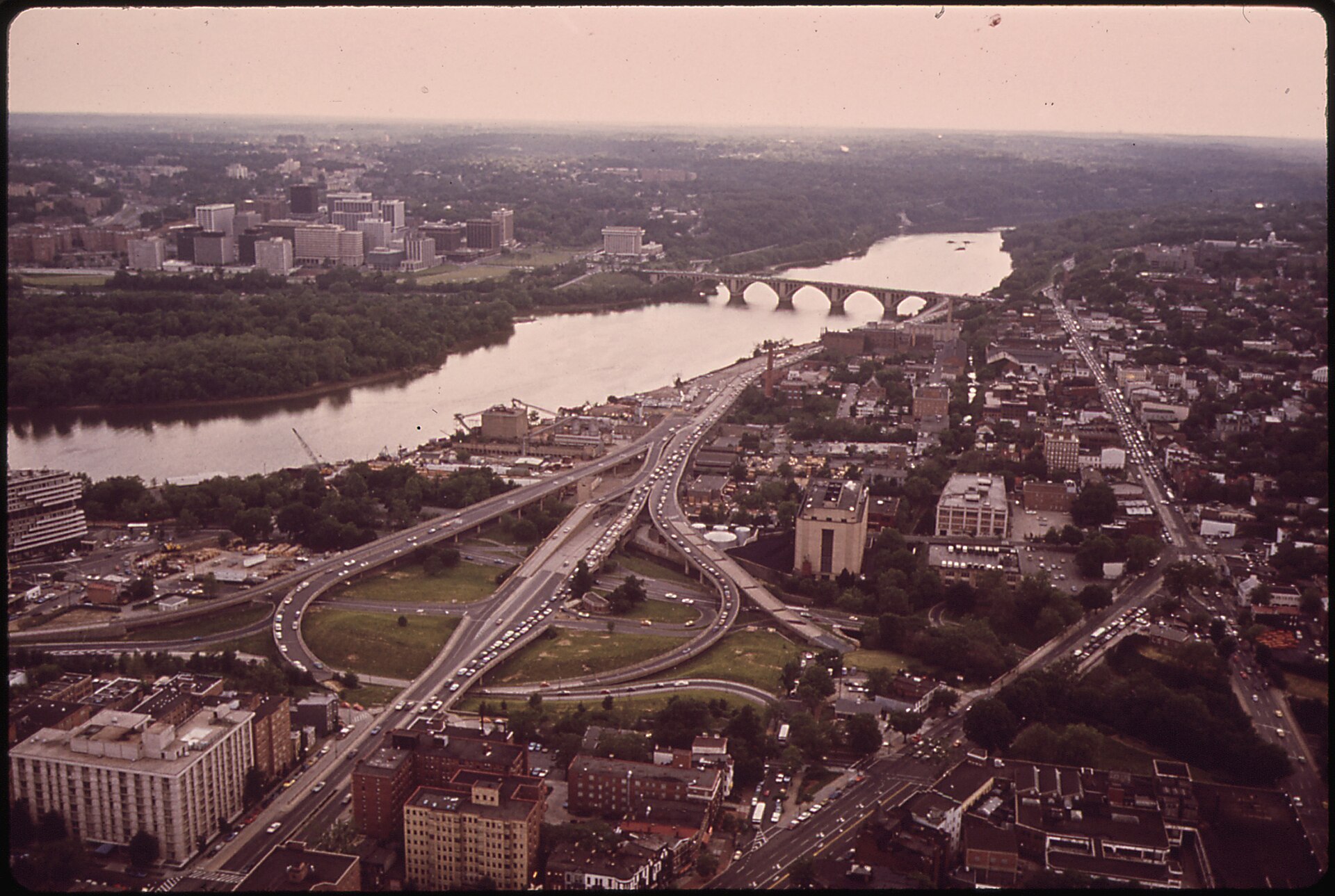 The elevated Whitehurst Freeway running along the Georgetown waterfront beside the Potomac River, photographed in May 1973 by Yoichi Okamoto for the National Archives.