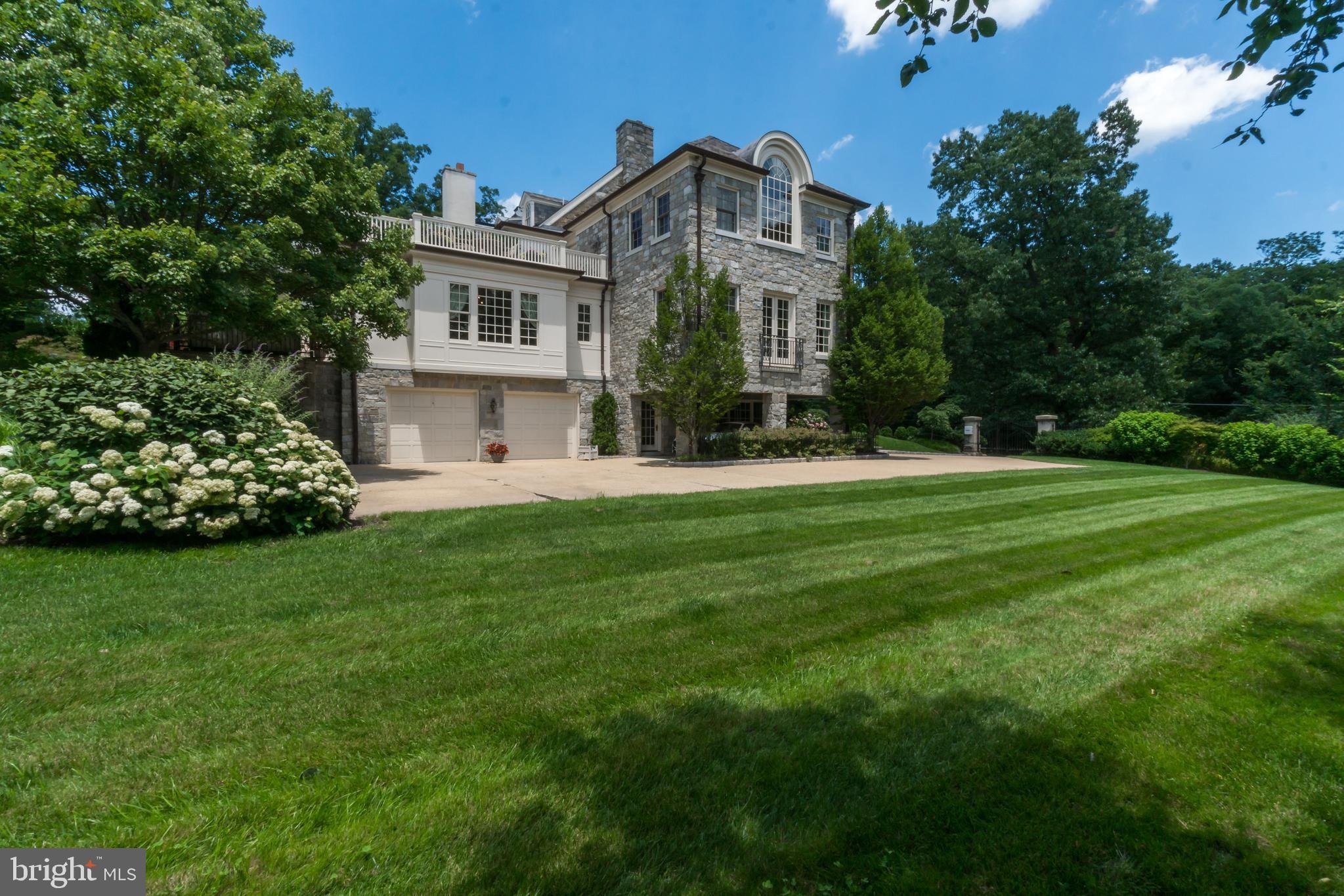 Highpoint, the former Senator Millard Tydings estate at 5320 27th Street NW in Chevy Chase DC, stone elevation facing the lawn toward Rock Creek Park. Courtesy of Washington Fine Properties.