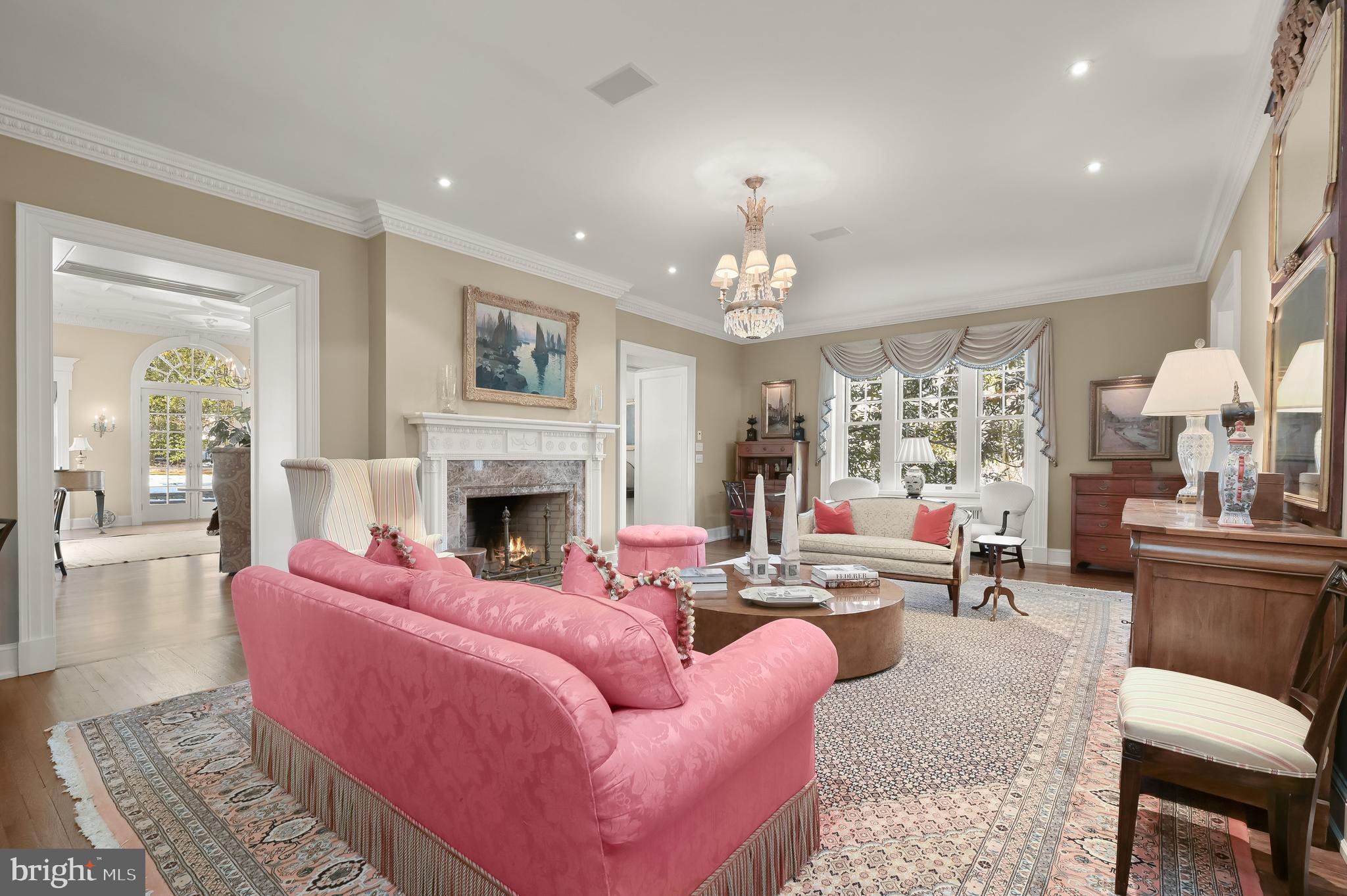 A formal reception room inside Highpoint, the former Tydings estate, with marble fireplace and chandelier. Courtesy of Washington Fine Properties.