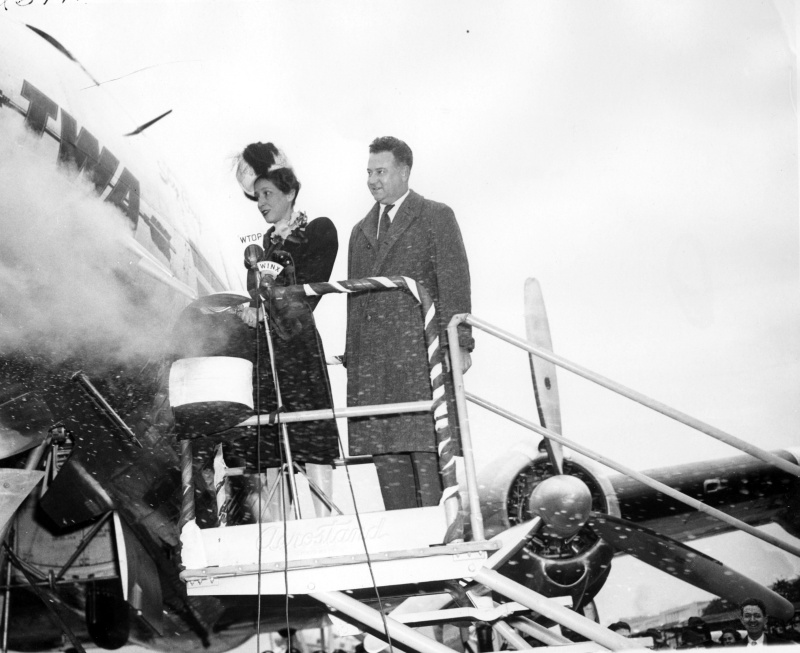Madame Henri Bonnet christens the TWA Lockheed Constellation "Paris Sky Chief" as TWA president Jack Frye looks on, December 1945