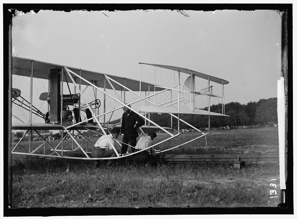 Wilbur and Orville Wright with mechanic Charlie Taylor placing the Flyer on the launching rail at Fort Myer, July 1909