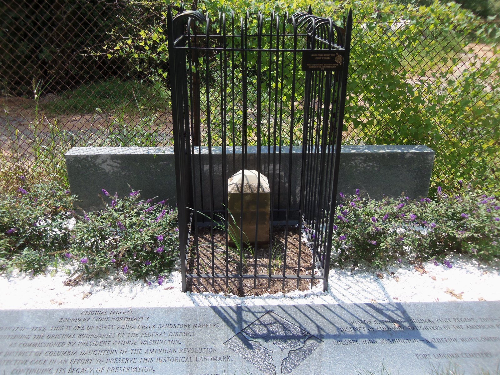 Northeast No. 7 DC boundary stone inside DAR iron fence at Fort Lincoln Cemetery