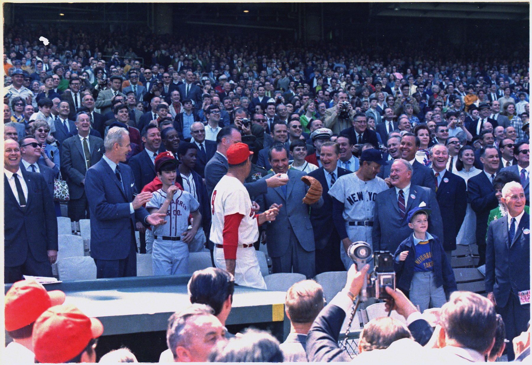 President Richard Nixon throws out the first pitch on Opening Day 1969 at RFK Stadium, with Senators manager Ted Williams, owner Bob Short, commissioner Bowie Kuhn, and Yankees manager Ralph Houk nearby