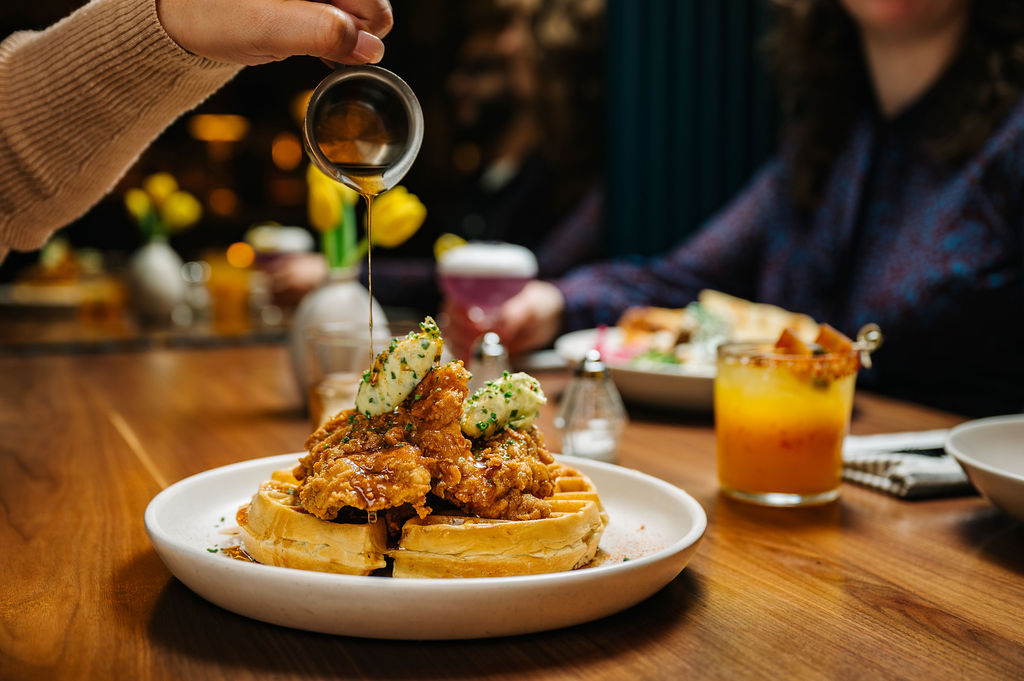 Ted's Bulletin brunch spread with chicken and waffles, cocktails, and pancakes