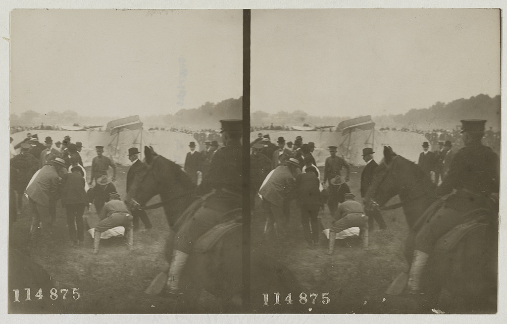 Officers and civilians tending to a crash victim moments after the Wright Flyer fell at Fort Myer, September 17, 1908