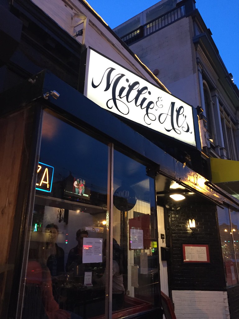 Millie and Al's storefront at dusk on April 6, 2016. Photo by Joe Flood via Flickr, used under CC BY-NC-ND 2.0.