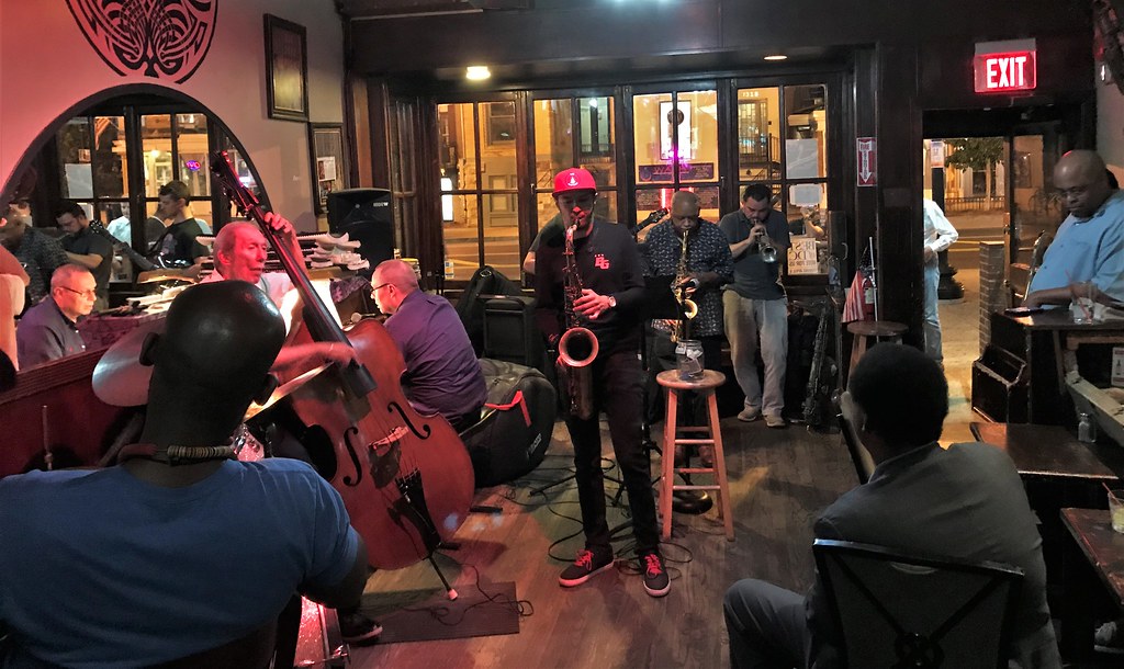 Jazz musicians performing in front of the arched French windows inside Columbia Station