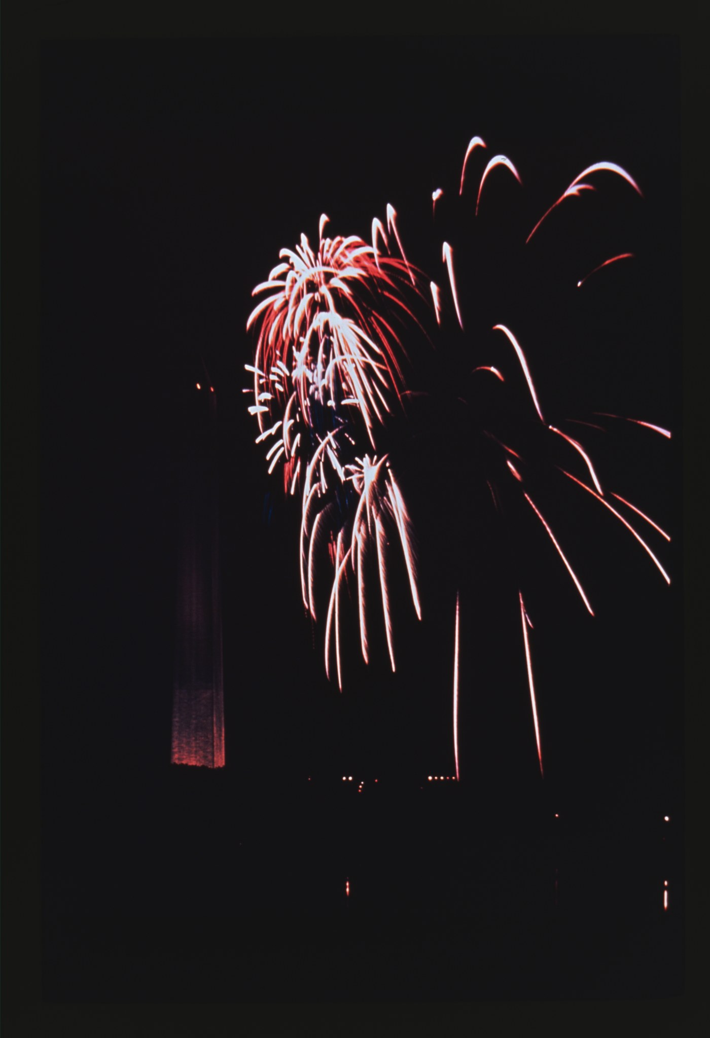 Fireworks bursting over the Washington Monument at night, photographed by Theodor Horydczak