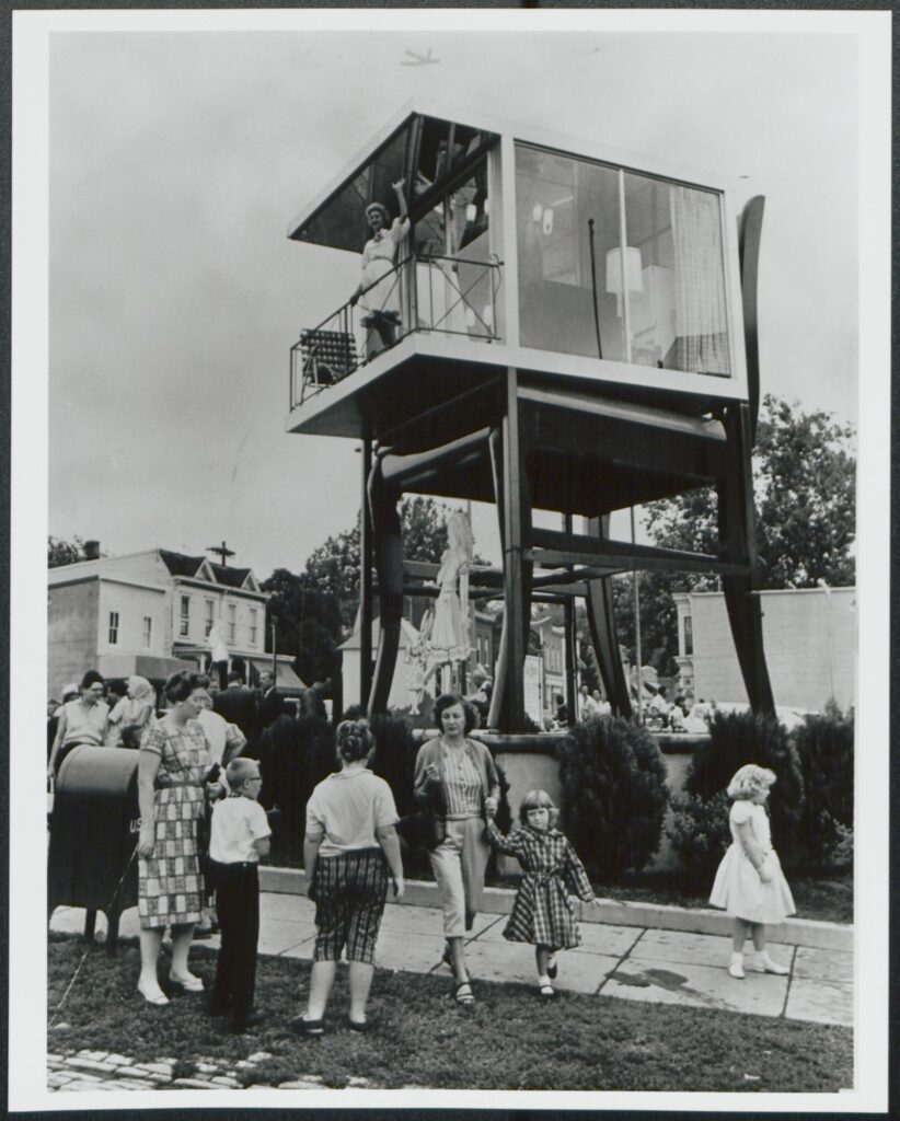 Lynn Arnold waves from the glass house atop the Big Chair in Anacostia, 1960