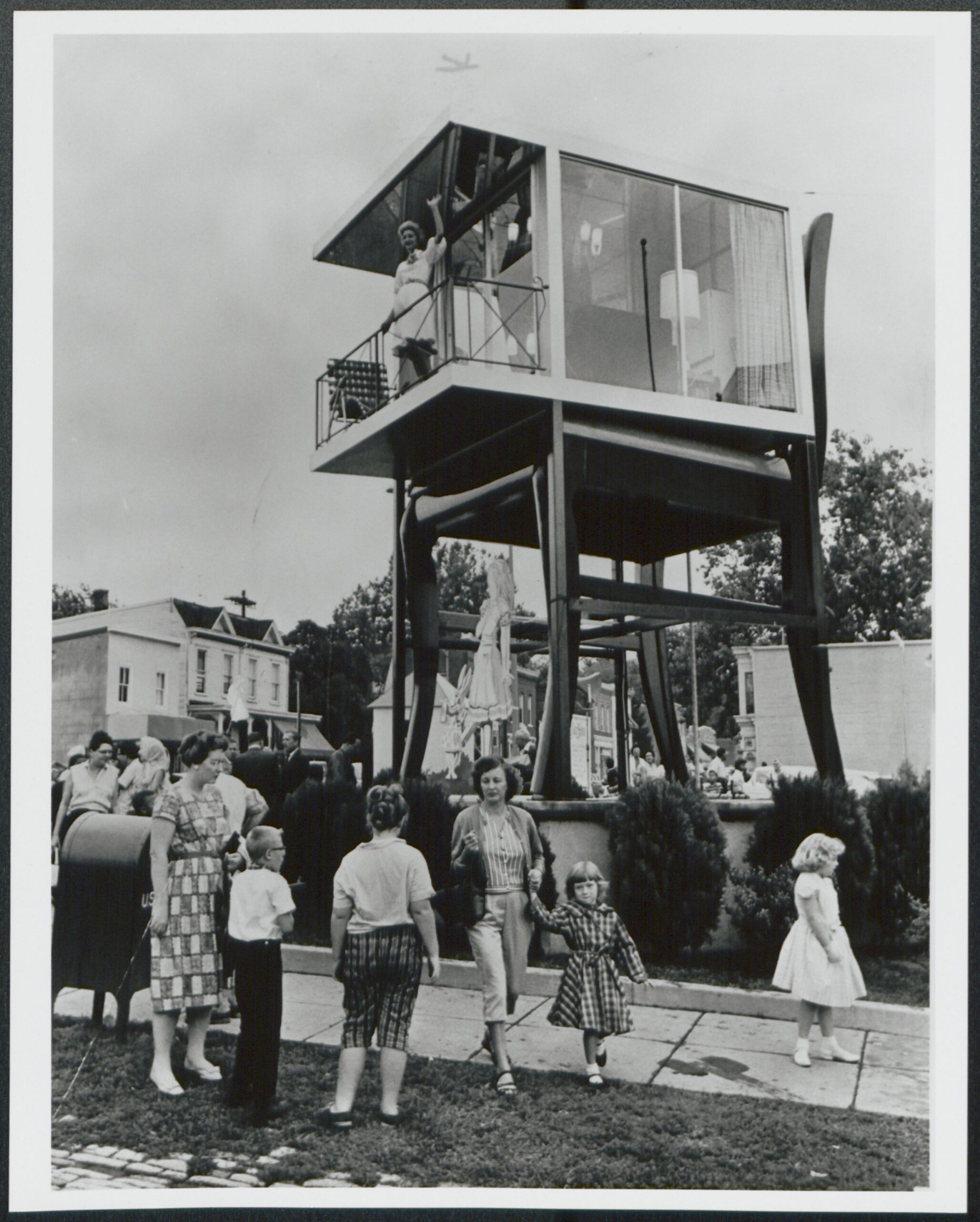 Lynn Arnold waves from the glass house atop the Big Chair in Anacostia, 1960