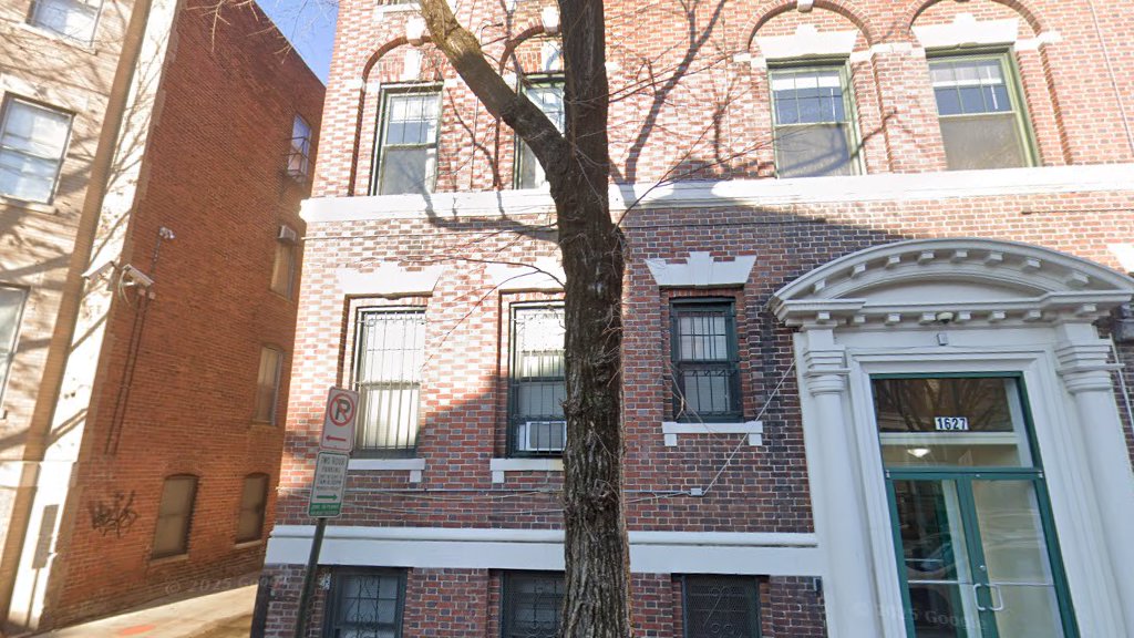 The four-story brick facade of 1627 Lamont Street NW today