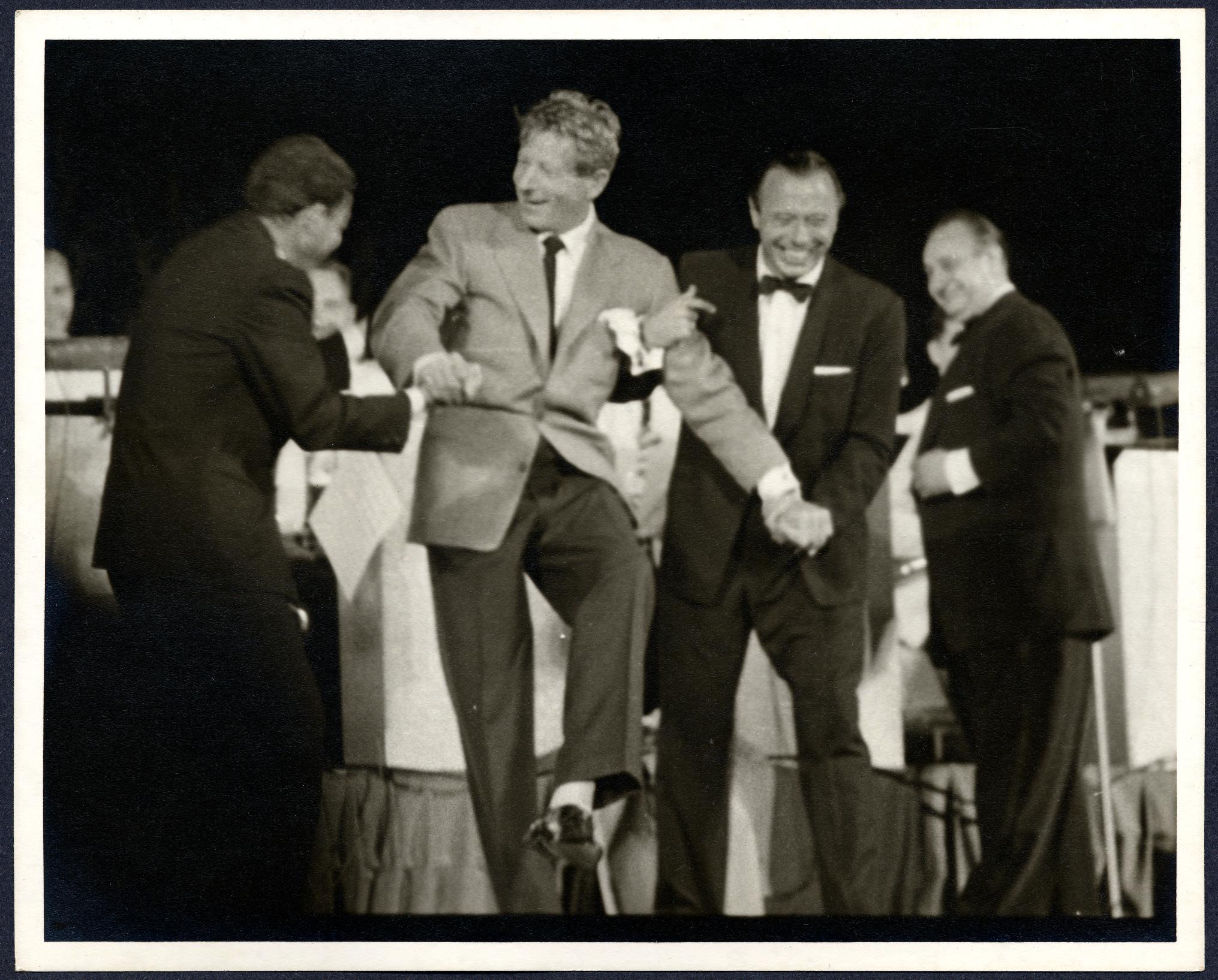 Danny Kaye laughs with band members onstage at Carter Barron Amphitheater in 1956