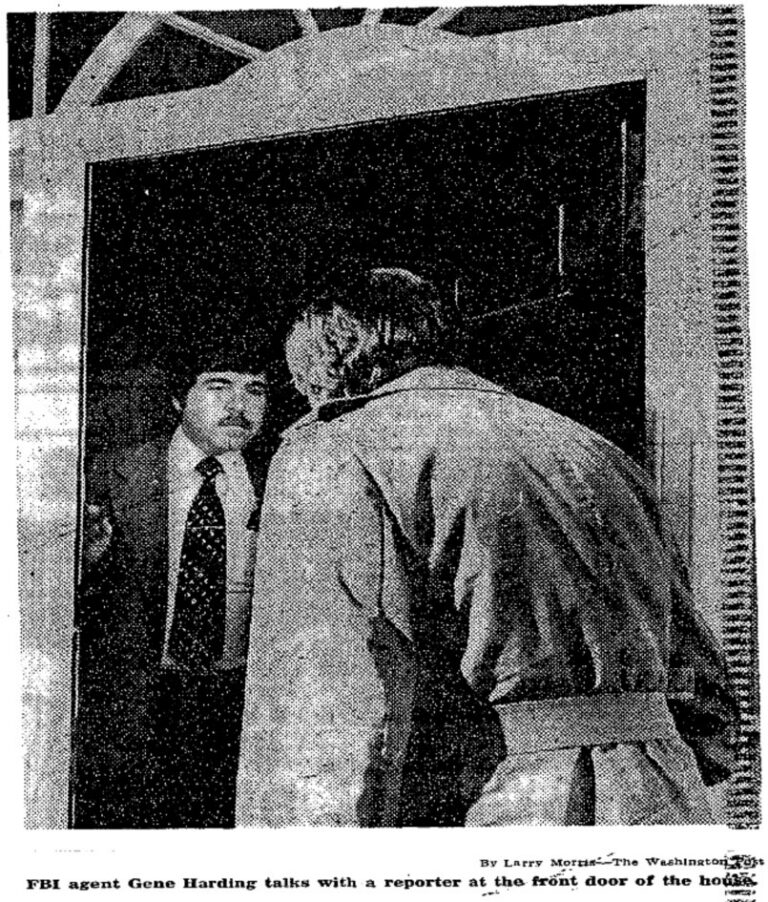 FBI agent Gene Harding standing in the front doorway of 4407 W Street NW talking with a reporter in February 1980