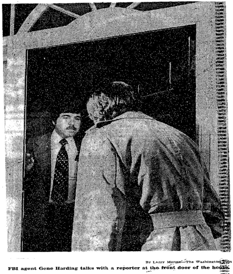 FBI agent Gene Harding standing in the front doorway of 4407 W Street NW talking with a reporter in February 1980