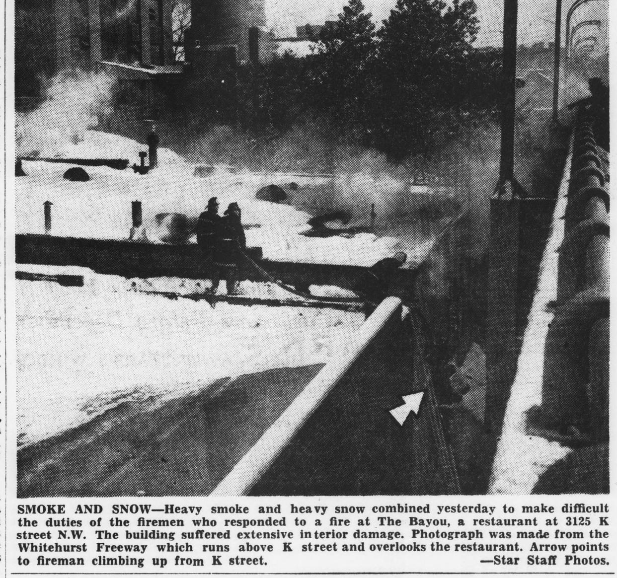 Firemen fight a fire at The Bayou in heavy snow on November 7 1953, photographed from the Whitehurst Freeway